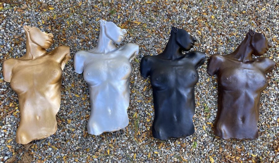 Four female body forms in gold, silver, black, and brown